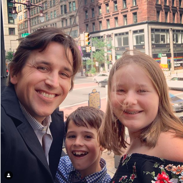 Lilliana's husband with their daughter and son, enjoying a happy family moment.